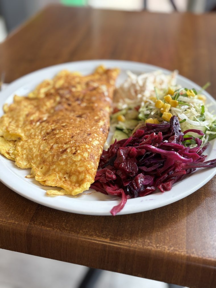 A folded omelette with shredded salad and red cabbage